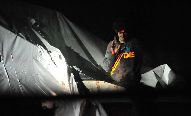 Alleged marathon bomber Dzhokhar Tsarnaev emerges from a boat in Watertown as he is captured. (Courtesy Sgt. Sean Murphy, via Boston Magazine)