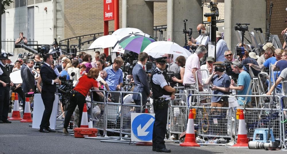 A British police officer, backdropped by members of the media, stands outside St. Mary's Hospital exclusive Lindo Wing in London, Monday, July 22, 2013. (Lefteris Pitarakis/AP)