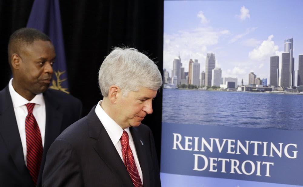 Michigan Gov. Rick Snyder, right, and state-appointed emergency manager Kevyn Orr leave a news conference in Detroit after addressing the city's bankruptcy, July 19, 2013. (Carlos Osorio/AP)
