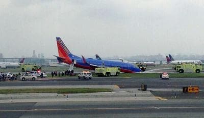 This photo provided by Bobby Abtahi, shows what officials say was a plane where the nose gear collapsed during landing at New York’s LaGuardia Airport, Monday, July 22, 2013. (Bobby Abtahi via AP)