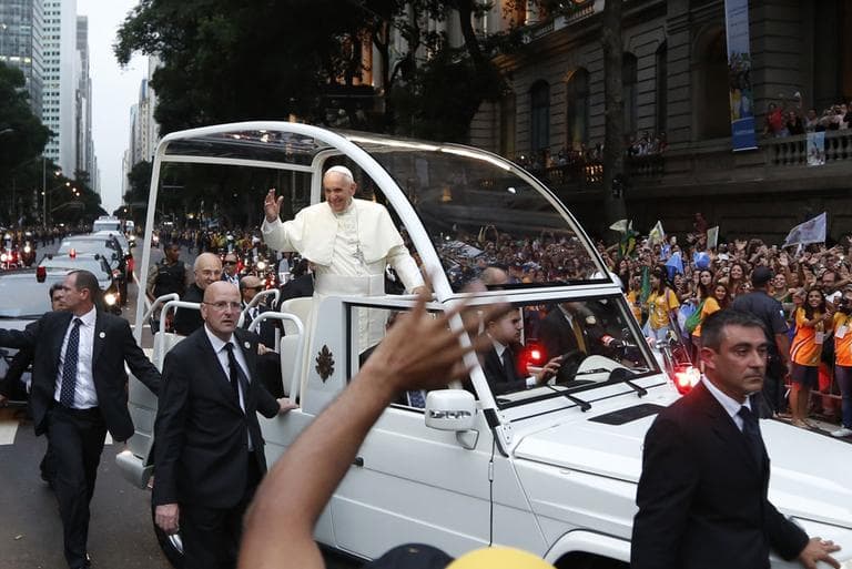 Pope Francis rides in his popemobile in Rio de Janeiro, Brazil, Monday July 22, 2013. (AP Photo/Victor R. Caivano)