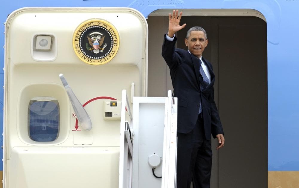 President Barack Obama waves as he boards Air Force One at Andrews Air Force Base, Md., Wednesday, July 24, 2013. Obama is traveling to Knox College in Galesburg, Ill., to kick off a series of speeches that will lay out his vision for rebuilding the economy. (Cliff Owen/AP)