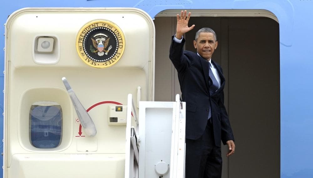President Barack Obama waves as he boards Air Force One at Andrews Air Force Base, Md., Wednesday, July 24, 2013. Obama is traveling to Knox College in Galesburg, Ill., to kick off a series of speeches that will lay out his vision for rebuilding the economy. (Cliff Owen/AP)