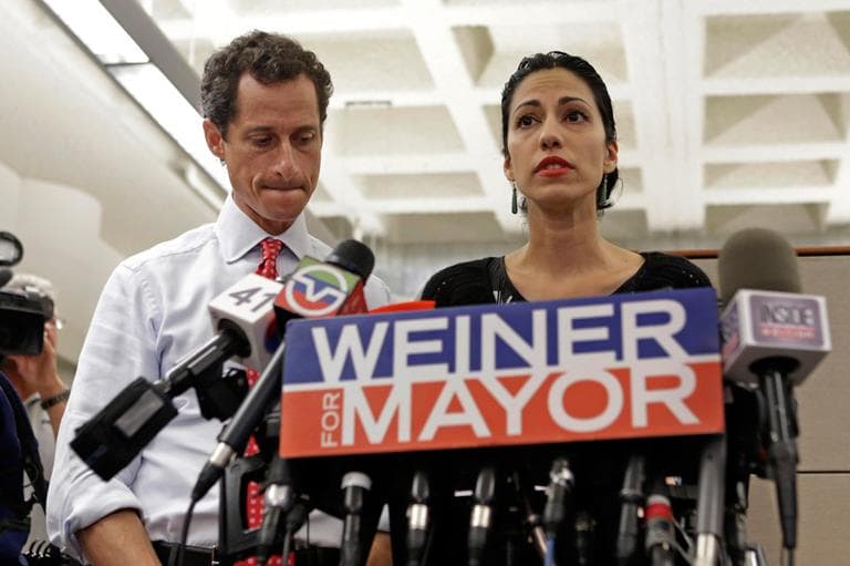 New York mayoral candidate Anthony Weiner, left, listens as his wife, Huma Abedin, speaks during a news conference on July 23, 2013, in New York. The former congressman says he's not dropping out of the New York City mayoral race in light of newly revealed explicit online correspondence with a young woman. (Kathy Willens/AP)
