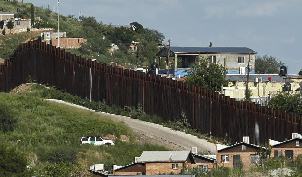 A U.S. Border Patrol vehicle keeps watch along the border fence in Nogales, Ariz., Thursday, Aug. 9, 2012. (Ross D. Franklin/AP)