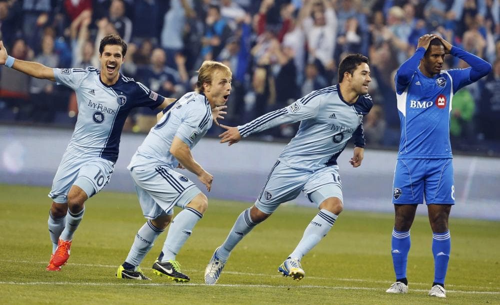 Sporting KC players Benny Feilhaber (10) and Seth Sinovic (15) celebrate a goal by Claudio Bieler (16), next to Montreal Impact midfielder Patrice Bernier (8) during the first half of an MLS soccer match in Kansas City, Kan., Saturday, March 30, 2013. (Orlin Wagner/AP)