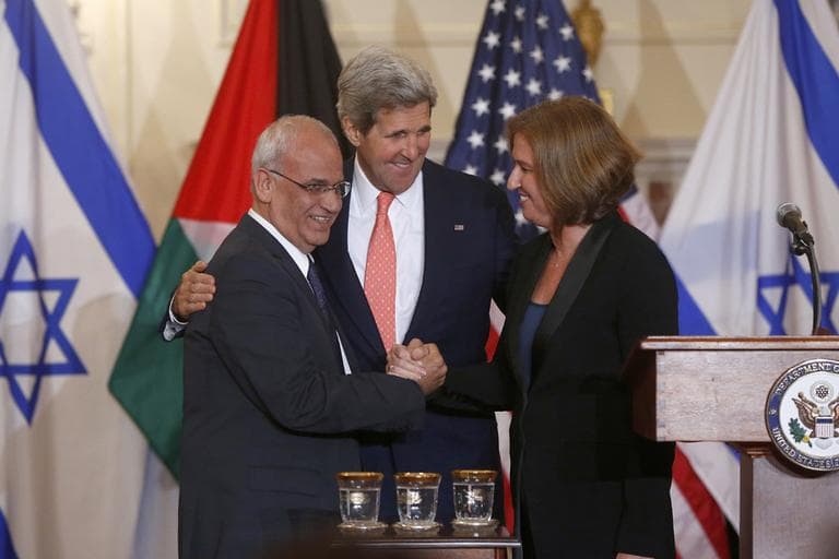 Secretary of State John Kerry stands between Israel's Justice Minister and chief negotiator Tzipi Livni, right, and Palestinian chief negotiator Saeb Erekat, as they shake hands after the resumption of Israeli-Palestinian peace talks, Tuesday, July 30, 2013, at the State Department in Washington. (Charles Dharapak/AP)