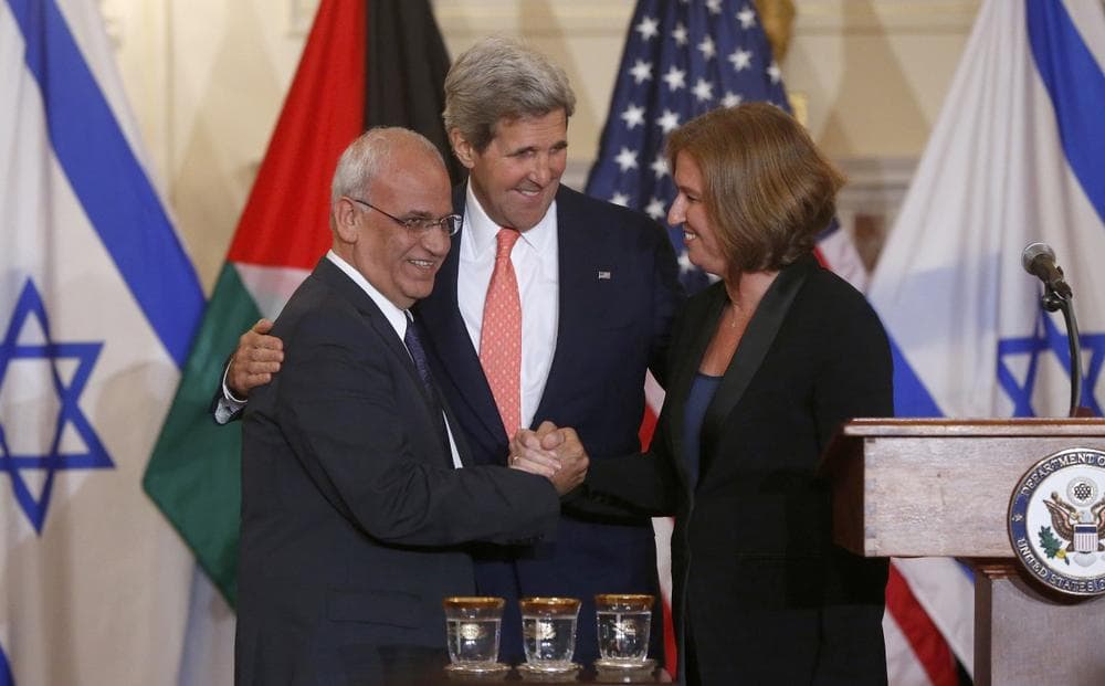 Secretary of State John Kerry stands between Israel's Justice Minister and chief negotiator Tzipi Livni, right, and Palestinian chief negotiator Saeb Erekat, as they shake hands after the resumption of Israeli-Palestinian peace talks, Tuesday, July 30, 2013, at the State Department in Washington. (Charles Dharapak/AP)