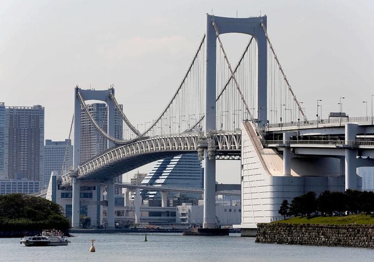 A ferry goes by the Rainbow Bridge in Tokyo, a single-span suspension bridge over half a mile long. (AP)