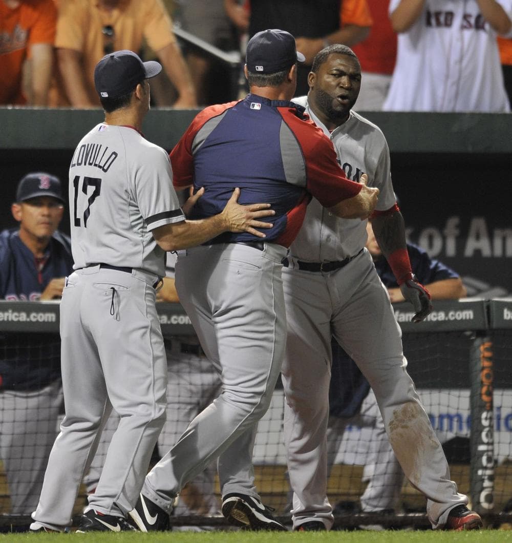 David Ortiz, right, is held back by manager John Farrell, center, and bench coach Torey Lovullo after being ejected by home plate umpire Tim Timmons. (AP) 