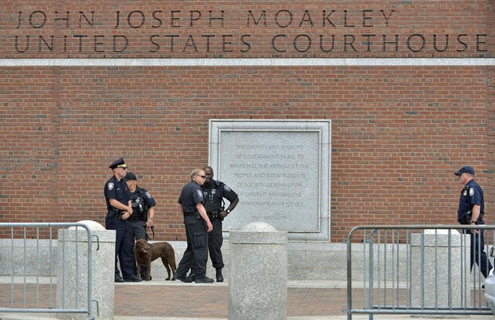 Federal law enforcement officers stand outside the federal courthouse prior to arraignment for Boston Marathon bombing suspect Dzhokhar Tsarnaev Wednesday, July 10, 2013, in Boston. The April 15 attack killed three and wounded more than 260. The 19-year-old Tsarnaev has been charged with using a weapon of mass destruction, and could face the death penalty.(AP Photo/Josh Reynolds)
