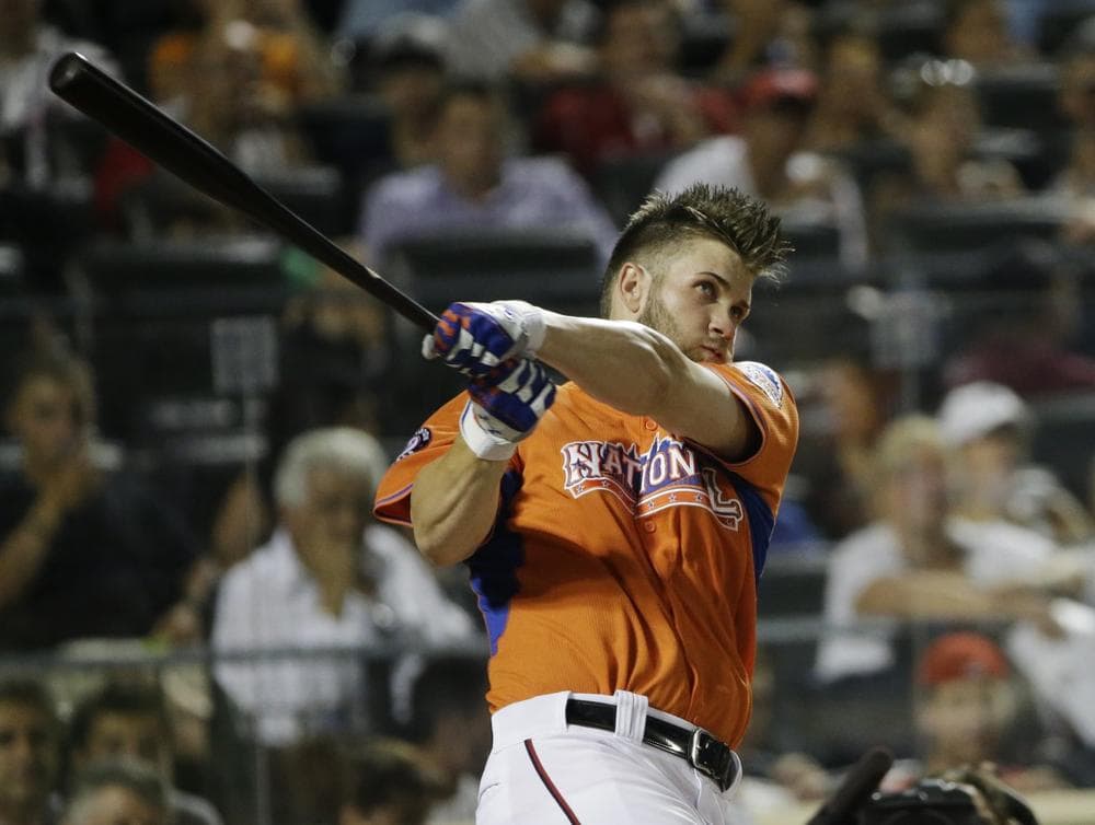 National League's Bryce Harper, of the Washington Nationals, watches his first home run in the third round of the MLB All-Star baseball Home Run Derby, on Monday, July 15, 2013 in New York. (AP)