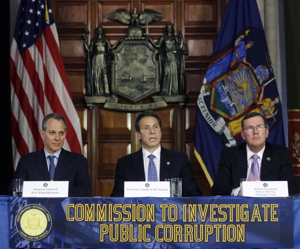 New York Gov. Andrew Cuomo, center, speaks during a news conference as New York Attorney General Eric Schneiderman, left, and Onondaga County District Attorney William Fitzpatrick listen on Tuesday, July 2, 2013, in Albany, N.Y. Cuomo has established a powerful investigative body to examine the state Board of Elections and potential wrongdoing by legislators in campaign fundraising. (AP/Mike Groll)