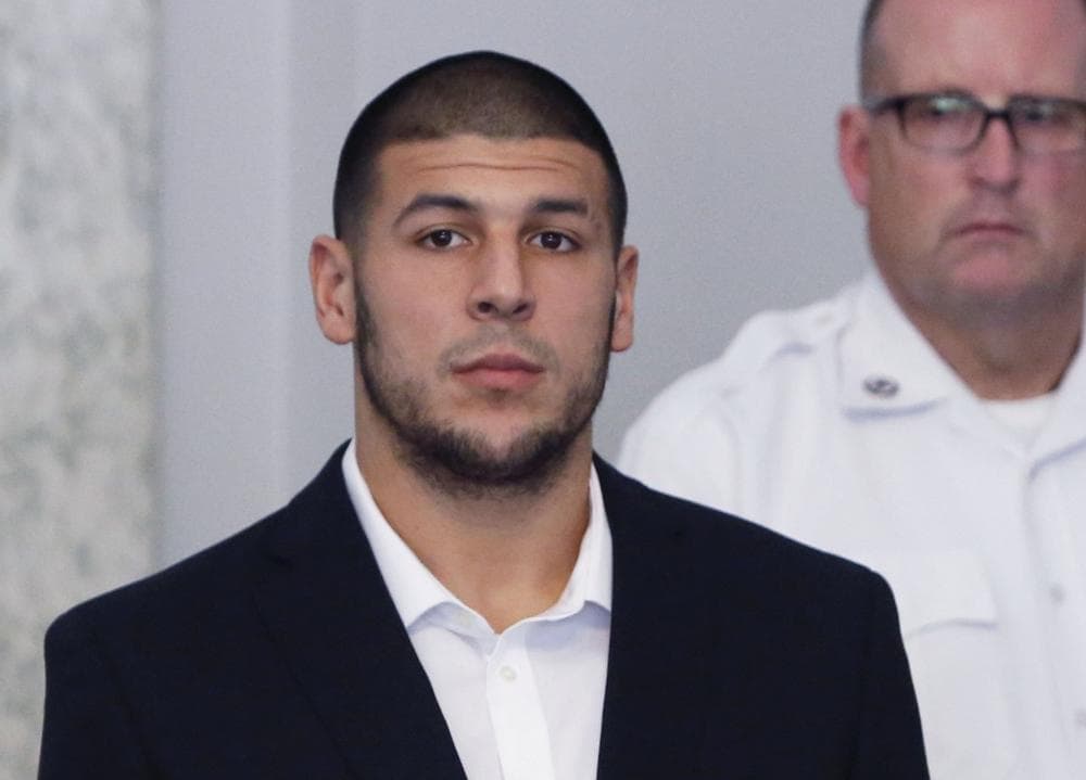 Former New England Patriots NFL football tight end Aaron Hernandez appears during a probable cause hearing at Attleboro District Court, on Wednesday, July 24, 2013, in Attleboro, Mass. Hernandez has pleaded not guilty to murder in the death of Odin Lloyd, a 27-year-old Boston semi-professional football player whose body was found June 17 in an industrial park in North Attleboro near Hernandez's home. (AP Photo/Bizuayehu Tesfaye)