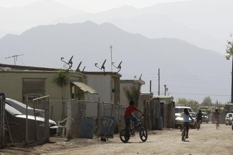 Children riding bikes at the desert mobile home park called &quot;Duroville&quot; in Thermal, Calif. After a decade of legal wrangling, the encampment known as Duroville was scheduled to close Sunday June 30, 2013, by court order. (AP)
