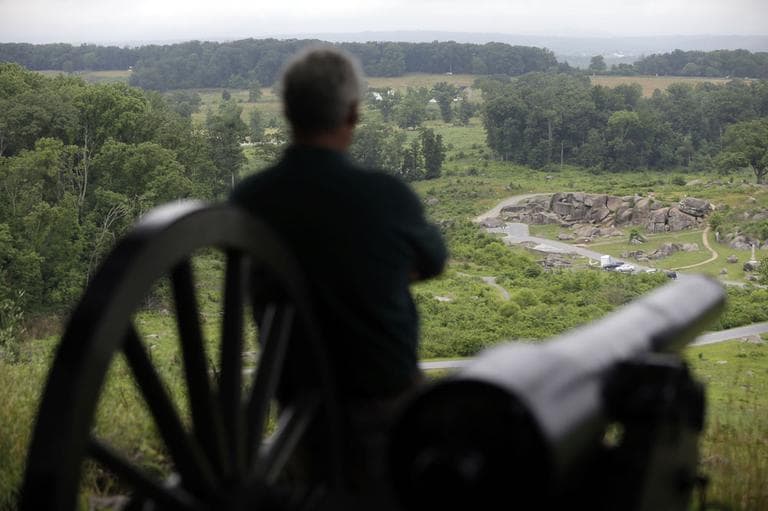 A visitor to Little Round Top views the Devil's Den during ongoing activities commemorating the 150th anniversary of the Battle of Gettysburg, Monday, July 1, 2013, in Gettysburg, PA. (AP)