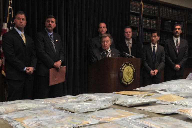 Weapons and drugs are on display as Queens District Attorney Richard Brown, center, speaks during a news conference, Friday, Jan. 13, 2012 in the Queens borough of New York. Brown says detectives arrested a dozen suspected drug dealers running an operation mostly out of Queens. They say suburban men and woman, mostly ages 20 to 25, would dial the dealers up, get on the Long Island Expressway and buy $400 worth of heroin.(AP)