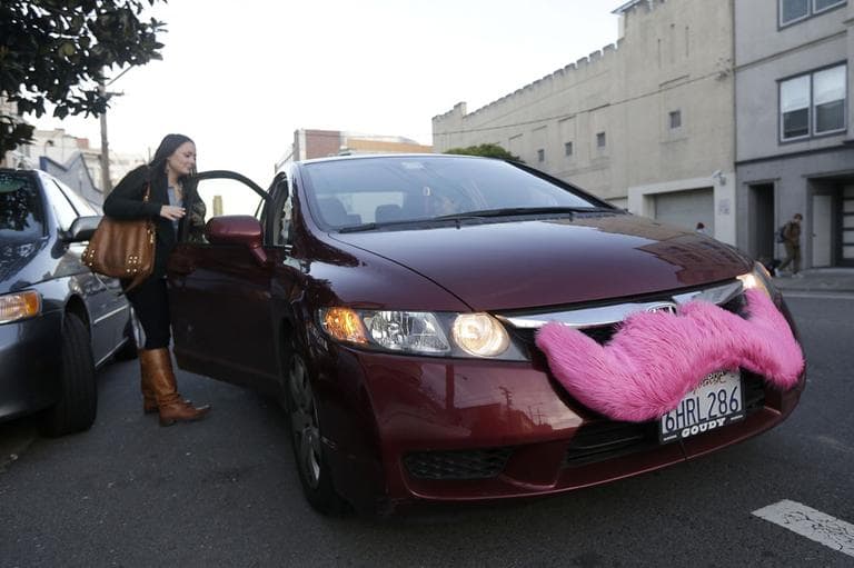 In this Jan. 4, 2013 photo, Lyft passenger Christina Shatzen gets into a car driven by Nancy Tcheou in San Francisco. Fed up with traditional taxis, city dwellers are tapping their smartphones to hitch rides from strangers using mobile apps that allow riders and drivers to find each other. Internet-enabled ridesharing services such as Lyft, Uber and Sidecar are expanding rapidly in San Francisco, New York and other U.S. cities, billing themselves as a high-tech, low-cost alternative to cabs. (AP)