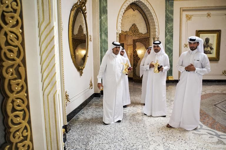 Men wait to serve tea to U.S. Secretary of State John Kerry, unseen, and Qatari Emir Hamad bin Khalifa Al Thani, unseen, during their meeting at Wajbah Palace in Doha, Qatar, on Sunday, June 23, 2013. (AP)