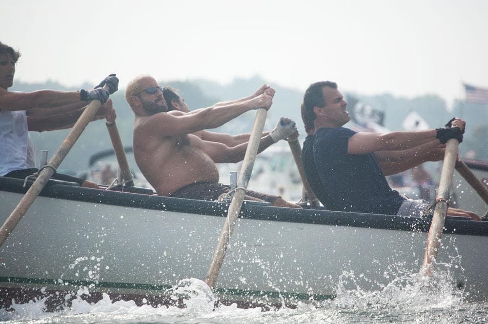 Seine boat racers strain at their oars during Sunday’s men’s championship race. (Greg Cook)