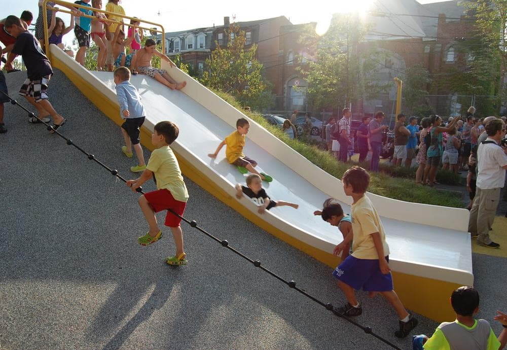 A wide slide built into the hills accommodates multiple children at once and is also handicapped accessible. (Greg Cook)