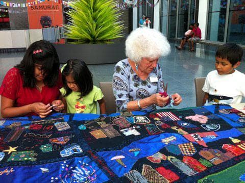 Clara Wainwright (center) guides work on the &quot;Mending Boston&quot; quilt at the Museum of Fine Arts. (Courtesy photo)