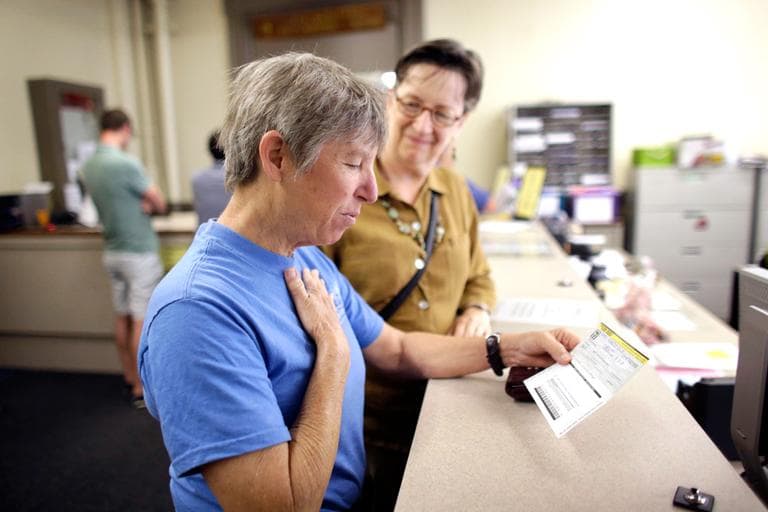 Lisa Kesser, front, reacts while completing paperwork to obtain a marriage license with her partner of 20 years, Dorcey Baker, at Providence City Hall Thursday. (Steven Senne/AP)