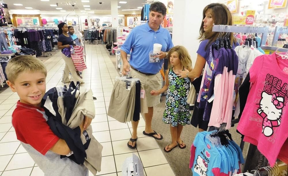 Andy and Aimee Smith, background, and their children Ian, left, and Riley shop for back-to-school clothes during the first day of the sales tax holiday at J.C. Penney in Eastdale Mall in Montgomery, Ala. in August 2011. (Mickey Welsh/Montgomery Advertiser via AP)