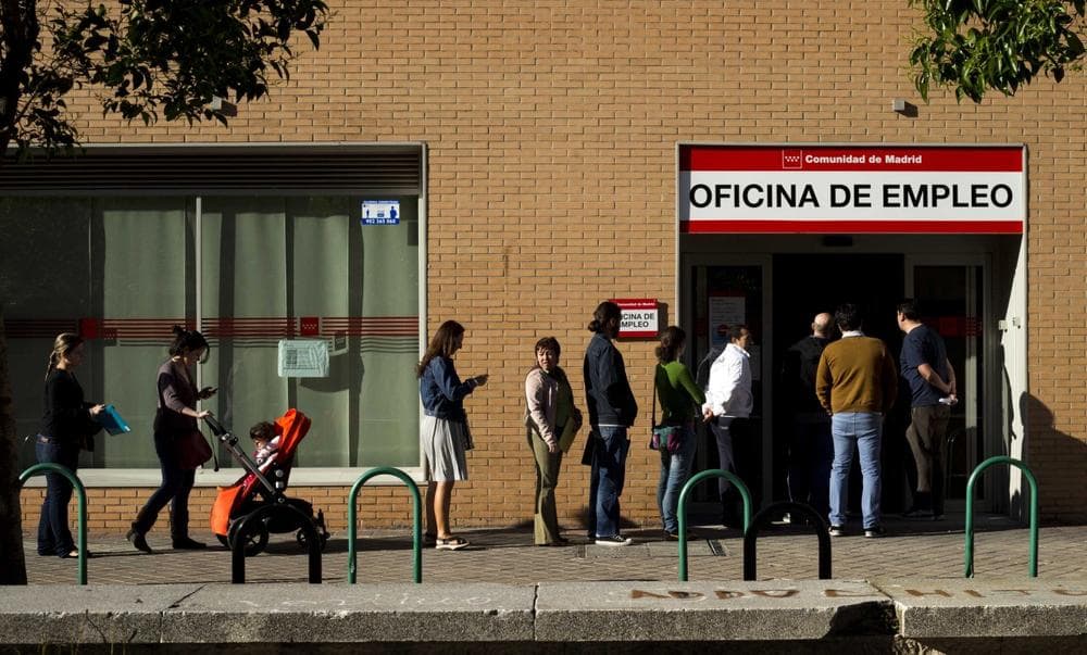 People queue up outside an unemployment registry office in Madrid, Spain, Tuesday, June 4, 2013. (Daniel Ochoa de Olza/AP)