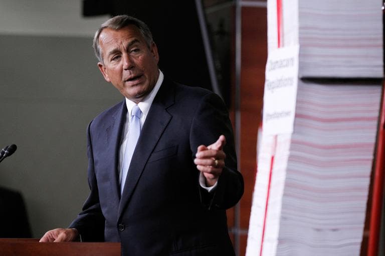In this May 16, 2013 file photo, House Speaker, Republican John Boehner of Ohio, points toward the tall stack of paper, representing 20,000 pages of Affordable Care Act regulations, during a news conference on Capitol Hill in Washington. The health care law has been a political prop for two election seasons already, but next year will be different. if the rollout of the law works reasonably well, particularly in states that have embraced it, there is an risk for Republicans, who have touted it as such a disaster that enraged voters will reward the GOP with undisputed control of Congress in next year's elections. (Molly Riley/AP File)