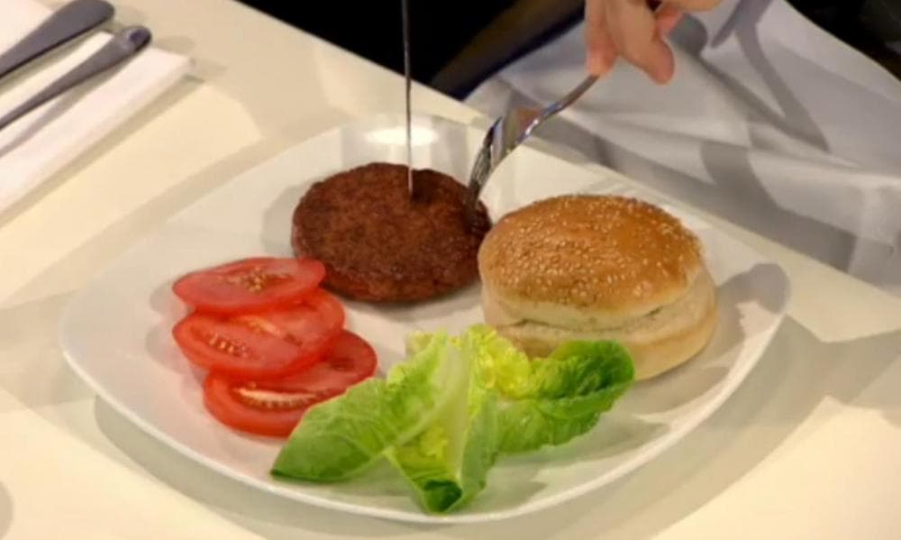 The world's first lab-grown hamburger is eaten in London. (BBC video screenshot)