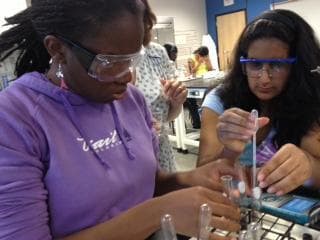 Quinita Thomas (left), who is blind, works with her partner in a Metro State University chemistry lab. (CPR)