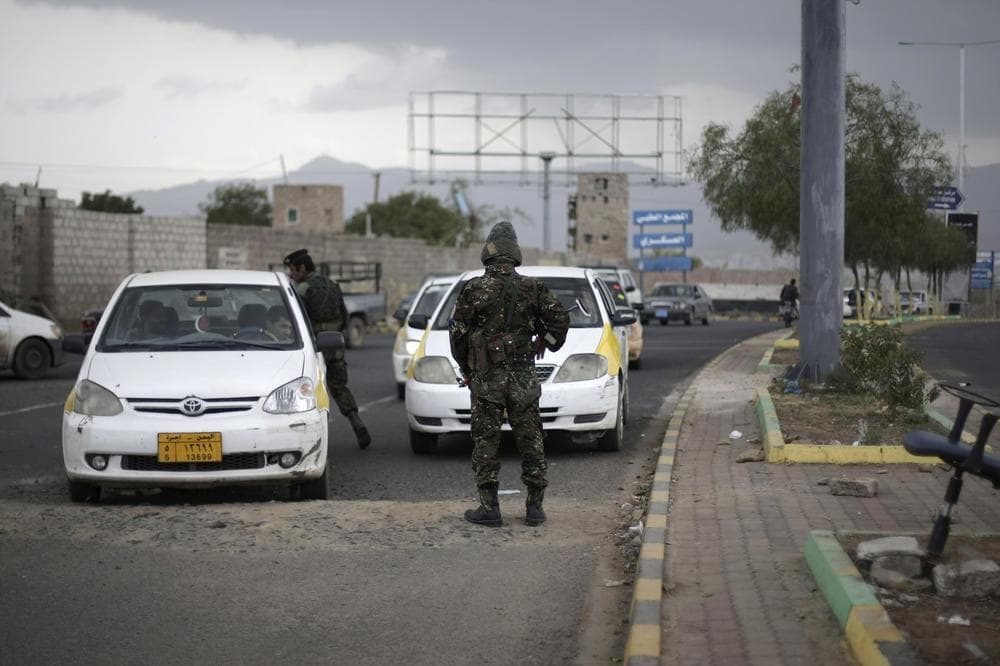 Police stop cars at a checkpoint near the U.S. embassy in Sanaa, Yemen. The State Department today ordered non-essential personnel at the U.S. Embassy in Yemen to leave the country. (Hani Mohammed/AP)