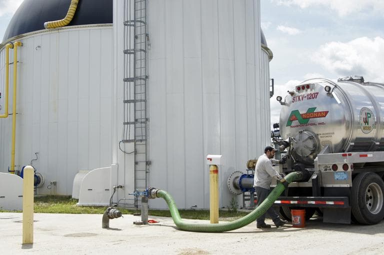 A truck driver offloads waste from Home Market Foods in Norwod into the anaerobic digester. (Lynn Jolicoeur/WBUR)