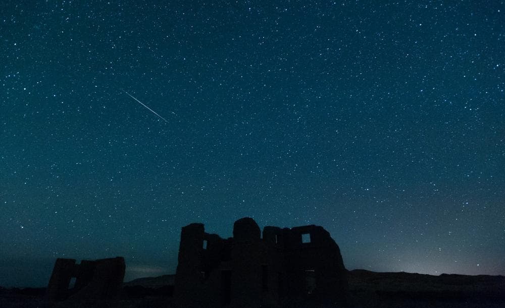 A meteor from the annual Perseid meteor shower falls from space over ruins at Fort Churchill State Historic Park on Sunday, Aug. 12, 2012, in Silver Springs, Nev. (Kevin Clifford/AP)
