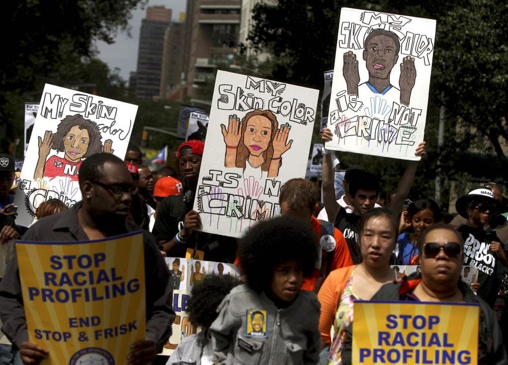 People hold signs during a silent march to end the &quot;stop-and-frisk&quot; program in New York, Sunday, June 17, 2012. Thousands of protesters from civil rights groups walked down New York City’s Fifth Avenue in total silence on Sunday as they marched in defiance of “stop-and-frisk” tactics employed by city police. (Seth Wenig/AP)