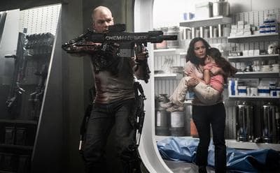 Max (Matt Damon) and Frey (Alice Braga) fight to get medical care for Frey's child in the film Elysium. (Sony Pictures)