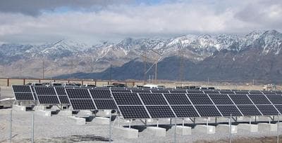 View of mountains and new solar panels at Bear River Migratory Bird Refuge in Utah. The Refuge continues to pursue sustainable electricity production with the addition of the solar panels near the James V. Hansen Wildlife Education Center. (Jason St. Sauver/USFWS via Flickr)