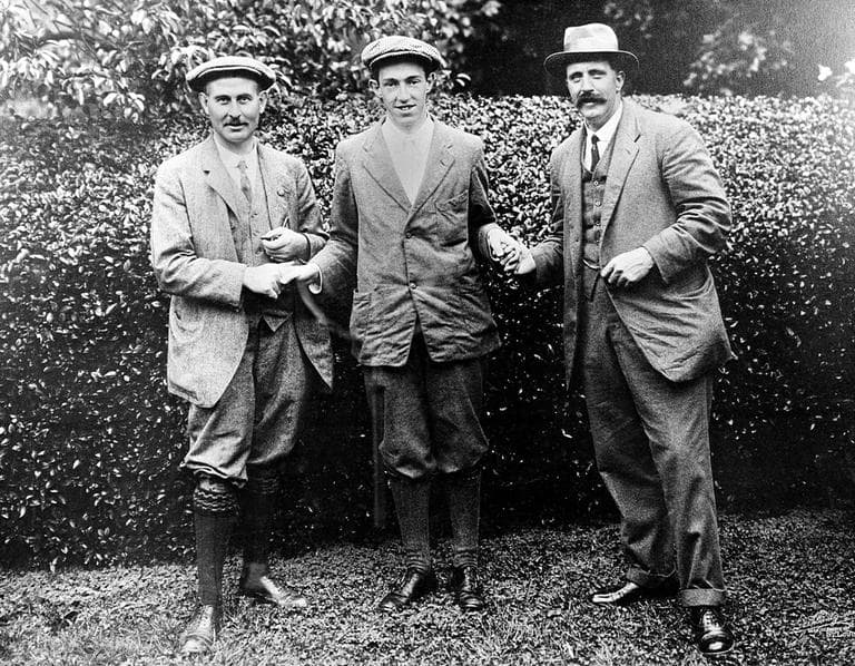 In this 1913 file photo, American golfer Francis B. Ouimet, center, shakes hands with Harry Vardon, left, and Ted Ray at the U.S. Amateur championship at The Country Club in Brookline, Mass. Ouimet's victory 100 years ago helped turn him and caddie Eddie Lowery into household names and boosted the sport's popularity in the United States. (AP)