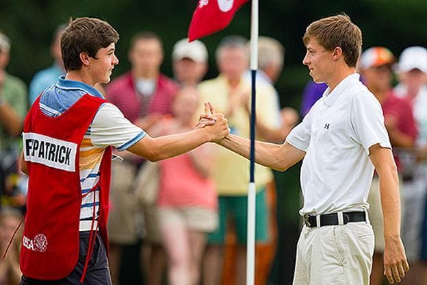 With his younger brother on the bag, Matthew Fitzpatrick (right) posted a 4-and-3 victory over Oliver Goss on Sunday to win the 2013 U.S. Amateur Championship. (John Mummert/USGA)