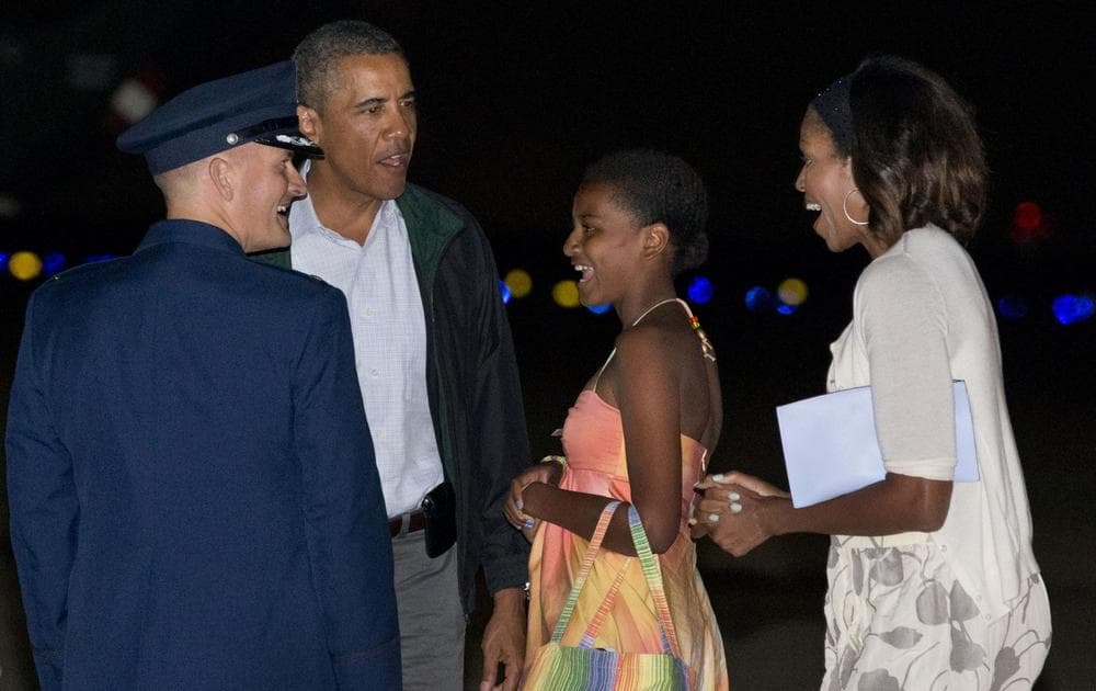 President Barack Obama, second from left, Sasha Obama, and first lady Michelle Obama, are greeted as they exit Air Force One on arrival at Andrews Air Force Base, Md., on Sunday Aug. 18, 2013, after a family vacation on the island of Martha&#039;s Vineyard. (Jacquelyn Martin/AP)