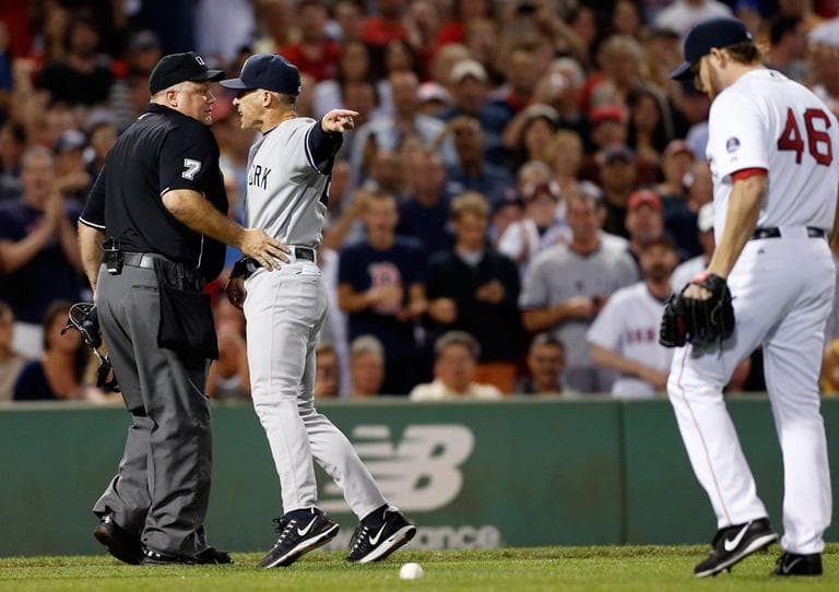Yankees manager Joe Girardi, center, points at Red Sox pitcher Ryan Dempster while arguing with home plate umpire Brian O'Nora, after Dempster hit Yankees Alex Rodriguez with a pitch in the second inning Sunday. (/Michael Dwyer/AP)