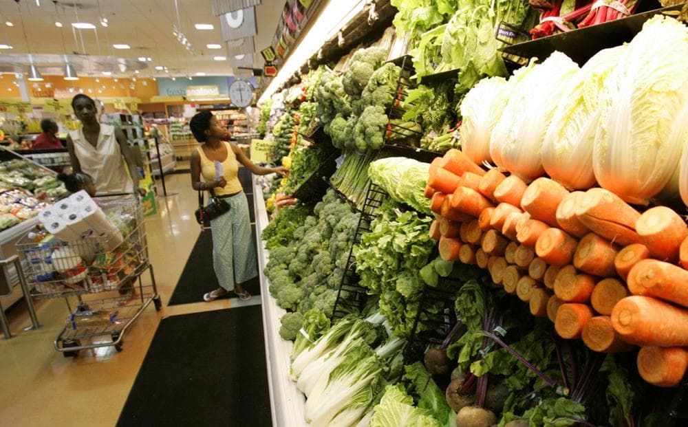 Shoppers peruse the produce section at The Fresh Grocer supermarket in West Philadelphia. (Coke Whitworth/AP)