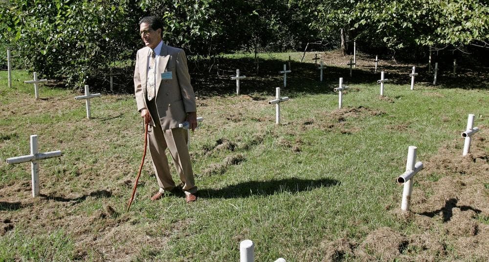 Dick Colon, a member of the White House Boys, walks through grave sites near the Arthur G. Dozier School for Boys in Marianna, Fla., Oct. 21, 2008. (Phil Coale/AP)
