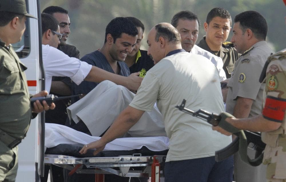 Egyptian medics share a laugh with former Egyptian President Hosni Mubarak, 85, as they escort him into an ambulance in, Cairo, Egypt, Thursday, Aug. 22, 2013. Mubarak has been released from jail and taken to military hospital in Cairo. (Amr Nabil/AP)