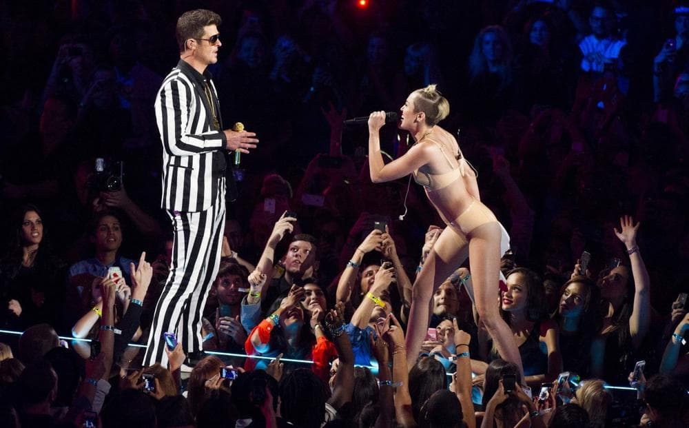 Robin Thicke, left, and Miley Cyrus perform &quot;Blurred Lines&quot; at the MTV Video Music Awards on Sunday, Aug. 25, 2013, at the Barclays Center in Brooklyn, New York. (Charles Sykes/Invision via AP)
