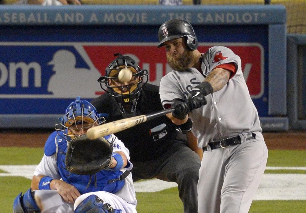 Boston Red Sox's Mike Napoli, right, hits a two-run home run as Los Angeles Dodgers catcher A.J. Ellis, left, and home plate umpire Brian Knight look on during the ninth inning. (AP/Mark J. Terrill)