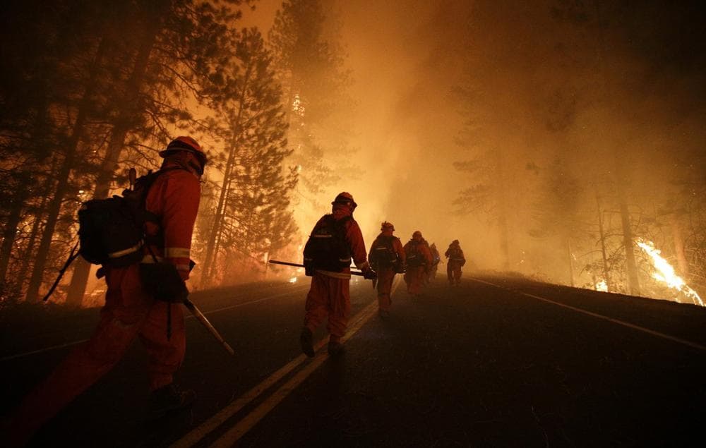 Inmate firefighters walk along Highway 120 as firefighters continue to battle the Rim Fire near Yosemite National Park, Calif., on Sunday, Aug. 25, 2013. (Jae C. Hong/AP)
