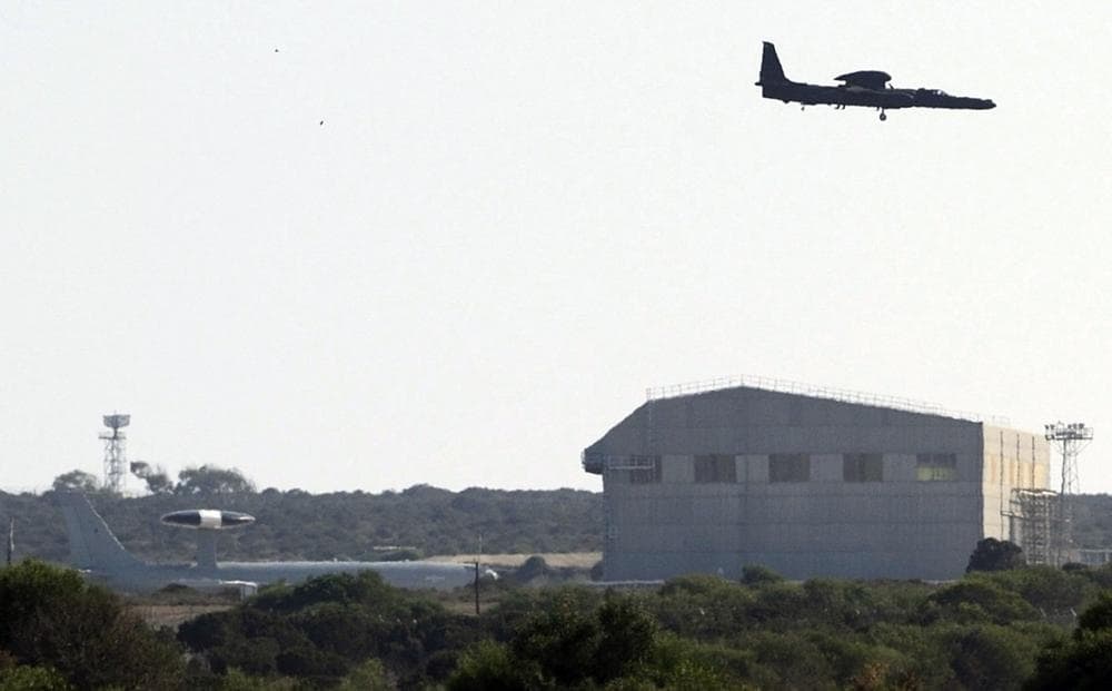 A military plane flies over Britain's airbase near Limassol, Cyprus, Wednesday, Aug. 28, 2013. (Pavlos Vrionides/AP)