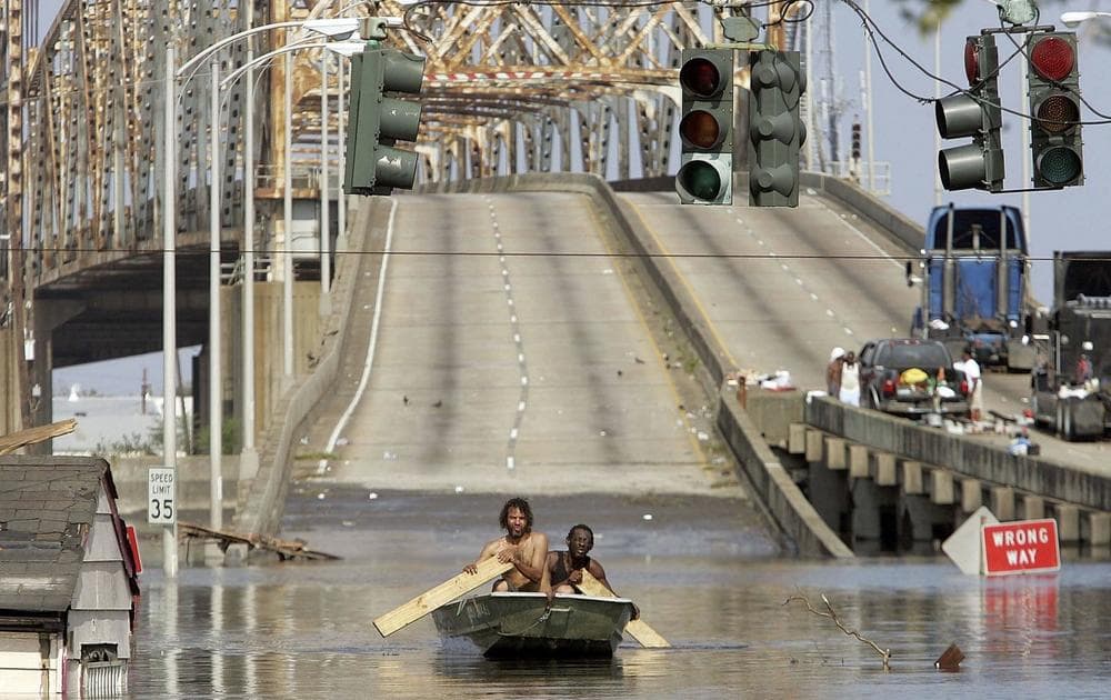 Two men paddle in high water after Hurricane Katrina devastated the area, August 31, 2005, in New Orleans, Louisiana. (PRNewsFoto/PBS)